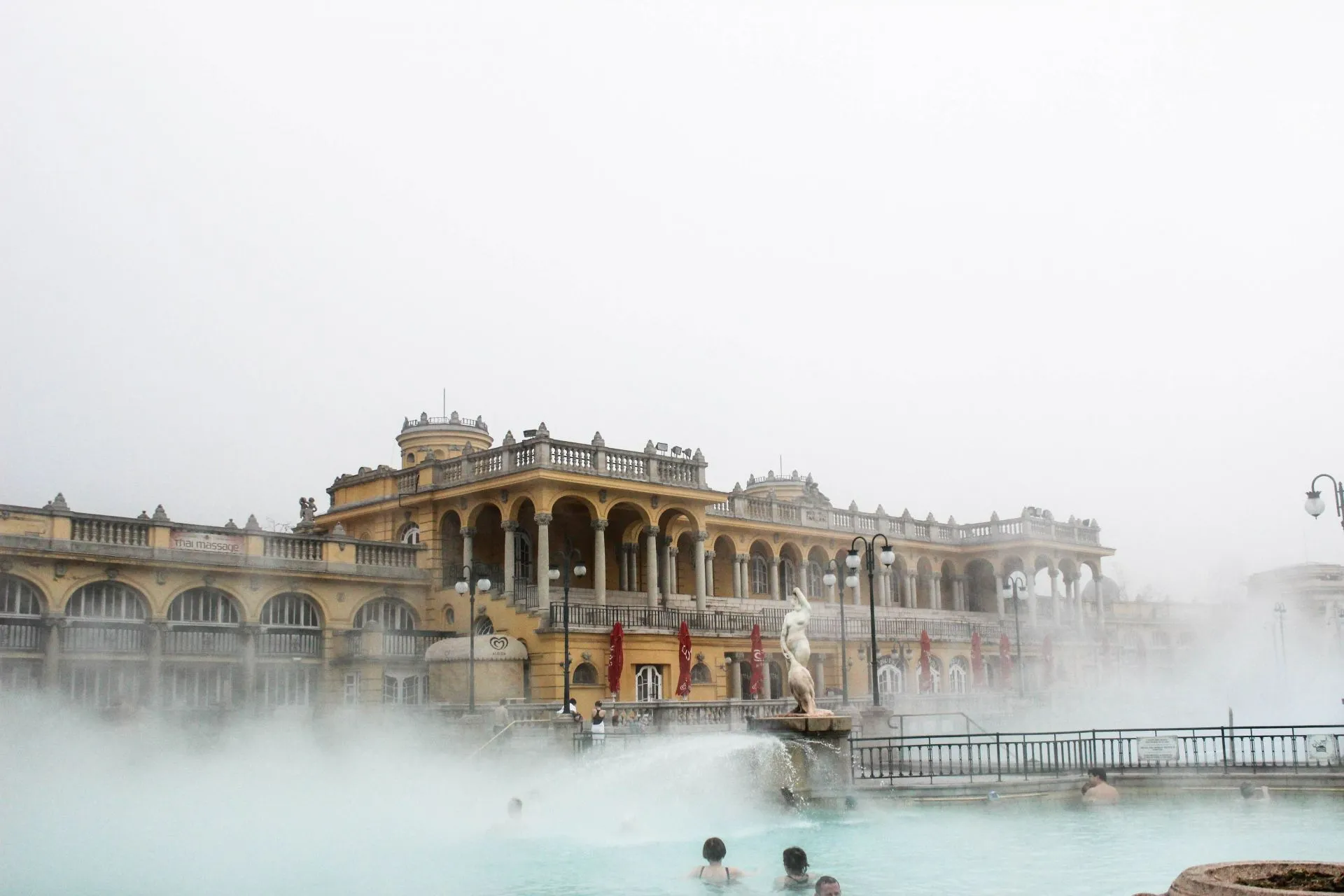 Morning vapour enveloping Széchenyi Baths yellow facade