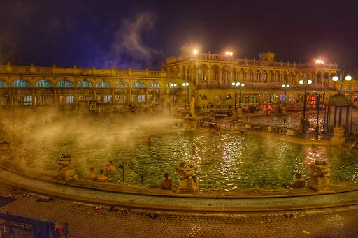 Illuminated night view of Széchenyi Baths outdoor pool